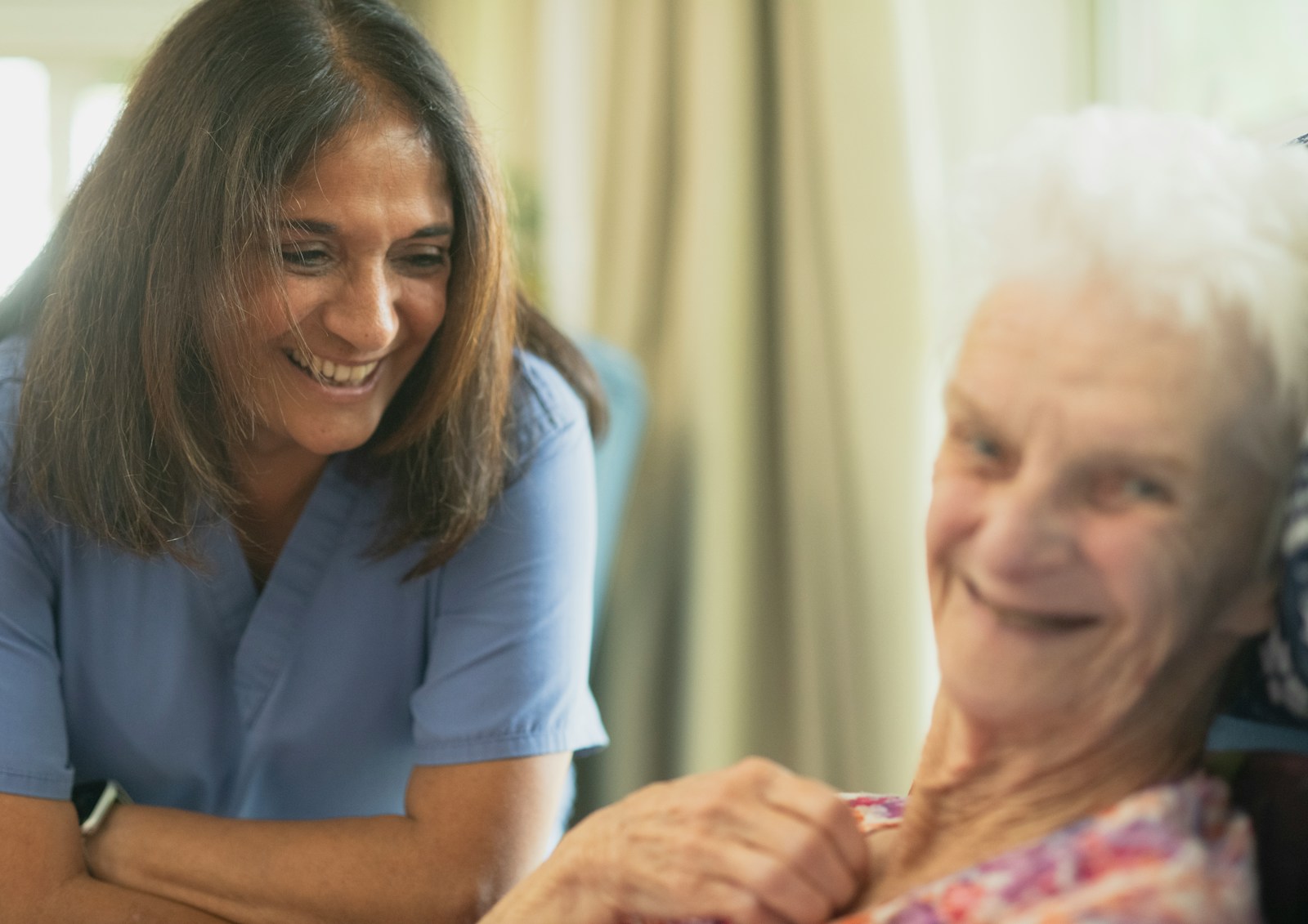 nurse supporting elderly patient